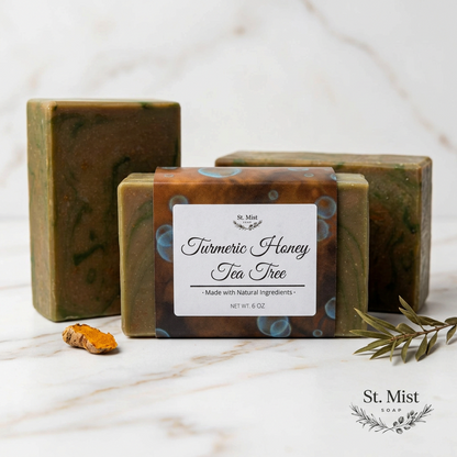 St. Mist Soap Turmeric Honey Tea Tree handcrafted soap bar with natural ingredients on a marble surface.